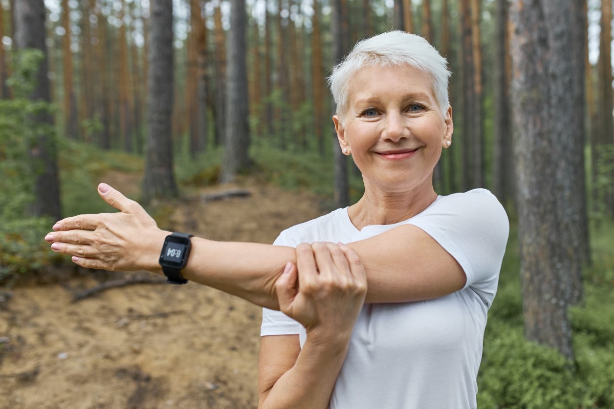 portrait-short-haired-retired-female-wearing-whit-t-shirt-smart-watch-her-wrist-track-progress-running